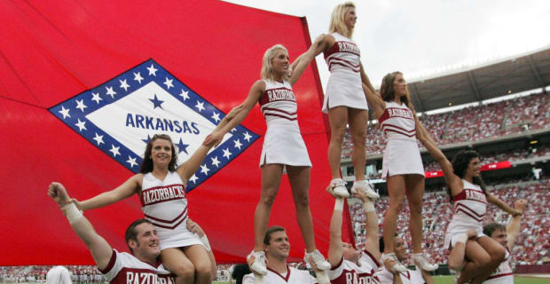 Cheerleaders celebrate a touchdown during an Arkansas Razorbacks college football game in the SEC.